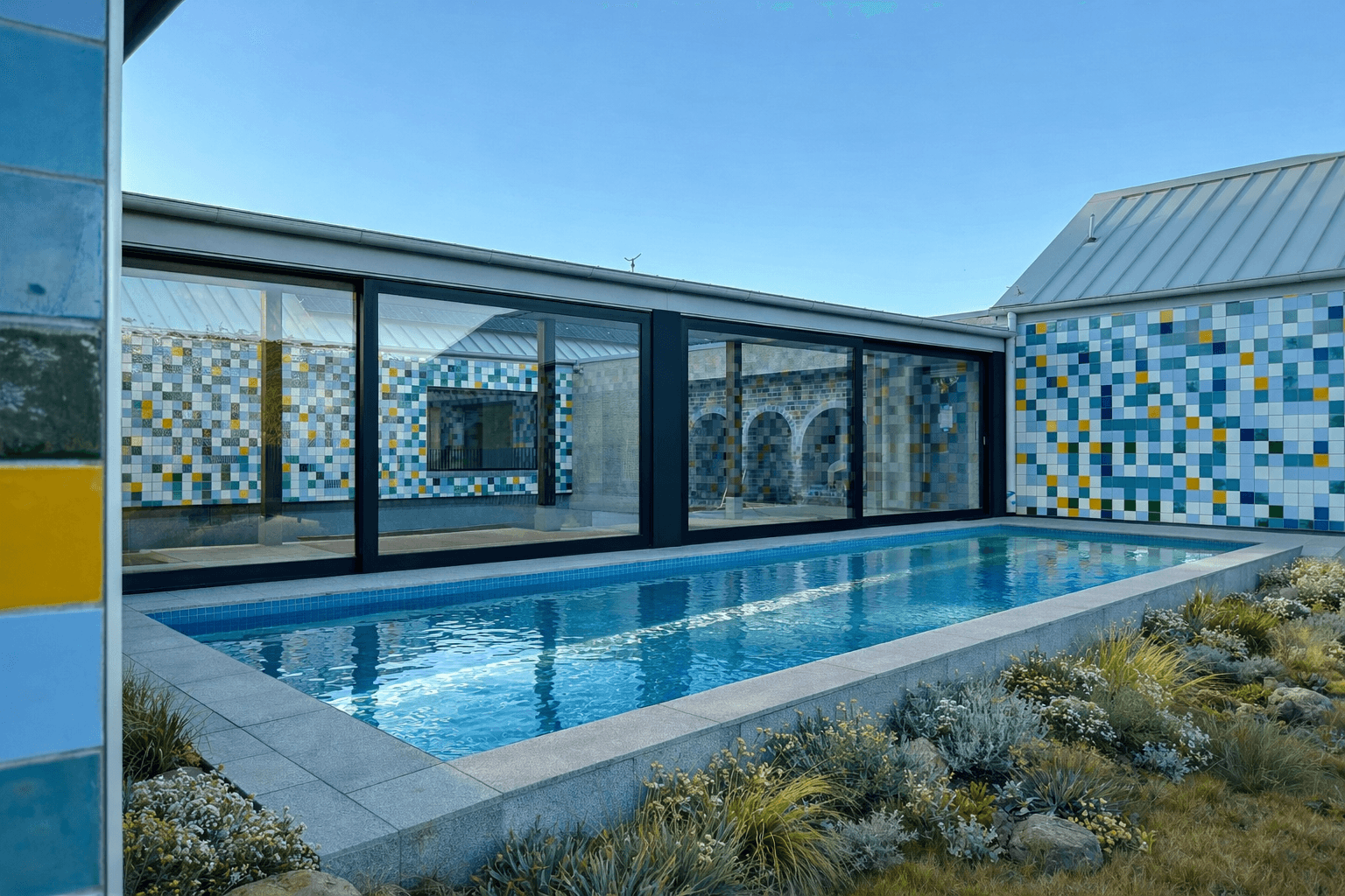 The tiled courtyard and lap pool enclosed by the pods