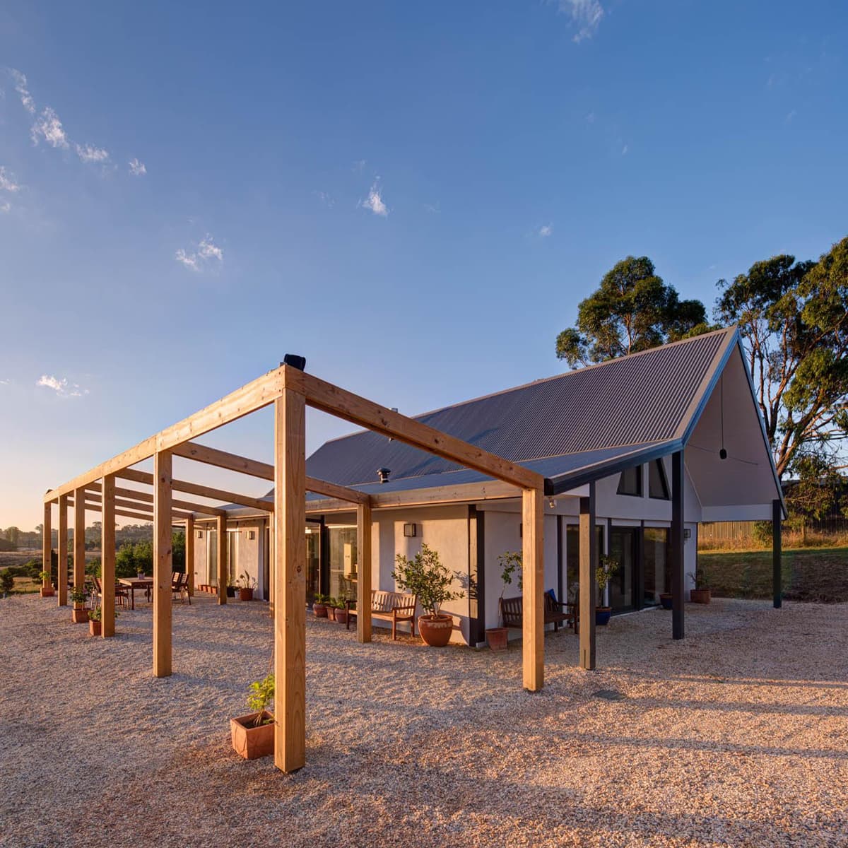 The single-storey mudbrick house at dawn, seen from the side and front